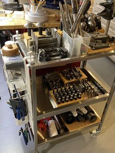 a workbench filled with tools and lots of clutter on top of it