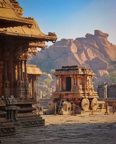 an ancient temple with mountains in the background