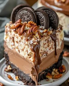 a piece of cake that is on a plate with some pecans and cookies around it