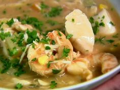 a close up of a bowl of soup with shrimp