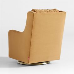 a tan chair sitting on top of a metal base