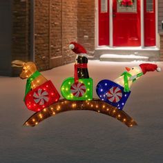 lighted christmas decorations in the shape of santas sleigh and reindeer on top of an arch