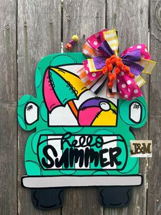 a wooden sign with the words rob's summer painted on it and an umbrella