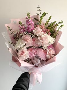 a person holding a bouquet of flowers in their hand