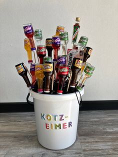 a white bucket filled with lots of different kinds of condiments