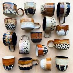 many coffee cups are stacked on top of each other in different shapes and sizes,