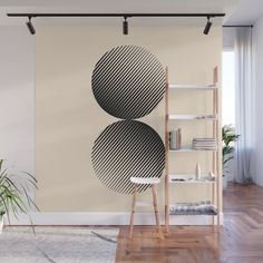 an abstract wall mural with three circles in black and white, on a beige background