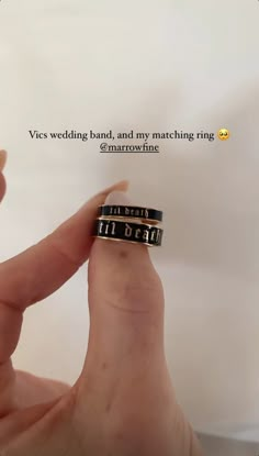 someone is holding up their wedding band with the words i'm dear written on it