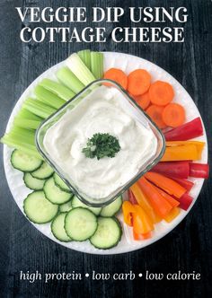 veggie dip using cottage cheese on a plate with carrots, cucumbers and celery