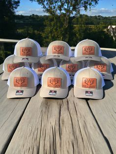 six hats sitting on top of a wooden table