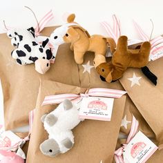 several small stuffed animals are wrapped in brown paper