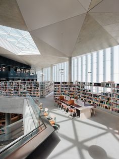 an empty library with many bookshelves and tables full of books in the middle