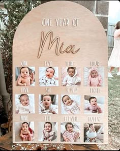 a wooden sign with pictures of babies on it that says one year of mea