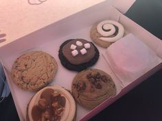 a box filled with assorted cookies and marshmallows