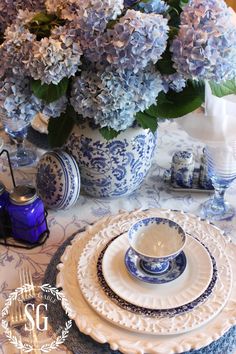 the table is set with blue and white dishes