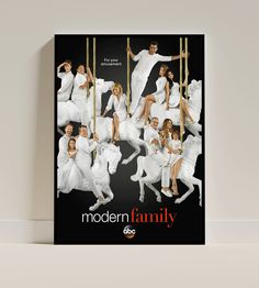 the modern family poster is hanging on a wall