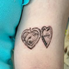 two heart shaped tattoos with a dog's face and name on the inside of them