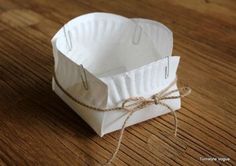 a white paper bag tied with twine on a wooden table, ready to be used as an ornament