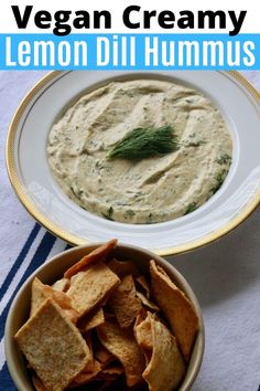 a white bowl filled with lemon dill hummus next to a bowl of chips