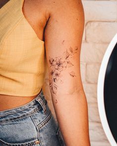 a woman with a flower tattoo on her arm