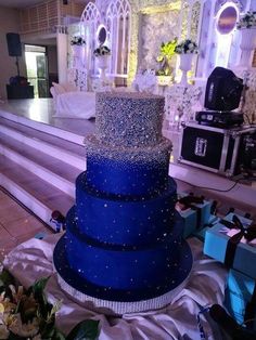 a blue wedding cake sitting on top of a table