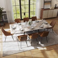 a dining room table with chairs and plates on it in front of a large window