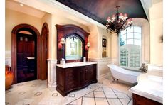 a large bathroom with two sinks and a bathtub in the middle of the room