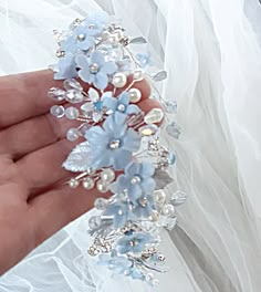 Light blue floral headpiece for the bride hairstyle. Dusty blue flowers crown for wedding. Pale blue bridal hairpiece with silver leaves. Wedding halo headpiece for bridal. More items from my shop: https://www.etsy.com/shop/JewelryforbridesShop?ref=seller-platform-mcnav The length of the accessory 54- 56cm (22").  Please look at matching earrings in my shop. Small handmade flowers and leaves , hand-painted with jewelry enamel, will perfectly decorate your hair. Headpiece very flexible/bendable for easy placement and can be worn in many different ways, depending on your hairstyle.   The headpiece ends with two loops that allow you to fasten it securely in your hair with bobby pins or secure with ribbon ties. CUSTOM ORDERS: I'm happy to create a custom order just for you! We can modify any d Elegant Light Blue Headpiece For Party, Light Blue Flower Jewelry For Wedding, Blue Summer Wedding Headpiece, Light Blue Headpieces For Spring Wedding, Light Blue Wedding Hair Accessories, Hydrangea Flower Crown, Wedding Halo Headpiece, Hair Headpiece, Hairpiece Wedding