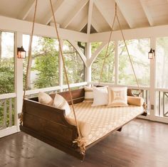 a porch swing bed with pillows on it