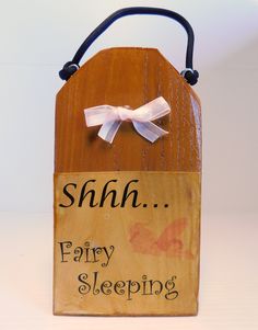 a wooden sign with a white bow on it that says, shhn early sleeping