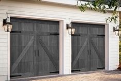 two garage doors are open in front of a white house