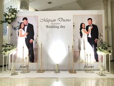 a couple standing next to each other in front of a wedding sign