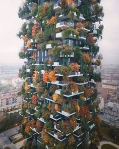 a very tall building with lots of plants growing on it