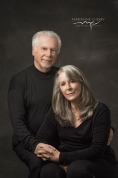 an older man and woman posing for a portrait