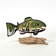 a fish on a wooden stand with a white background