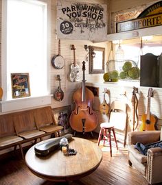 an image of a living room with guitars on the wall