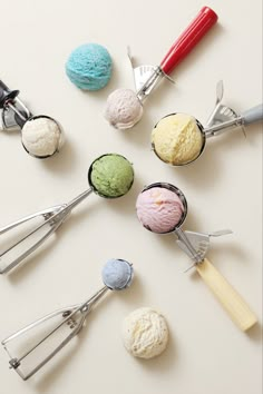 several scoops of ice cream sitting next to each other on a white counter top