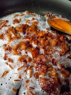 the food is being cooked in the pan on the stove with some oil around it