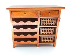 a wooden cabinet with several drawers and wine racks on the bottom shelf, against a white background