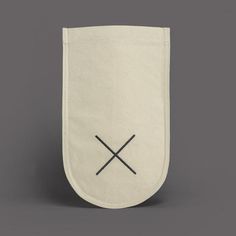 a white bag with two crossed swords on the front and bottom, in black ink