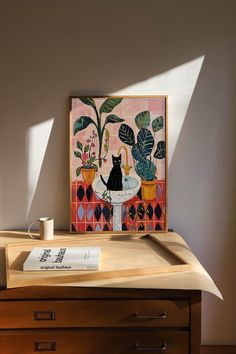 a painting sitting on top of a wooden table