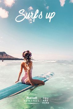 a woman sitting on top of a surfboard in the middle of the ocean wearing a flower crown