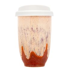 a cup that has some sauce on it and is sitting in front of a white background