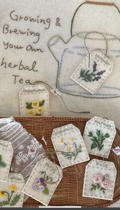 embroidered tea bags and coasters on a wicker basket