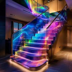 a spiral stair case with colorful lights on it