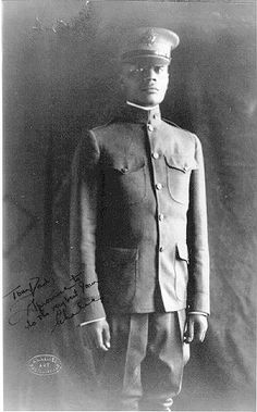 an old black and white photo of a man in uniform