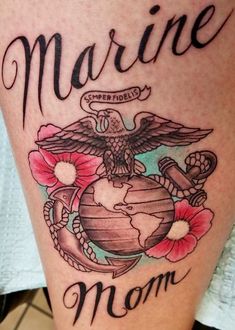 a marine mom tattoo with an eagle, globe and flowers on the thigh is shown