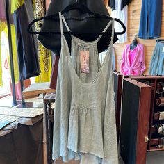 Experience pure summertime bliss with this Linen Cotton Blend distressed Hem tank top. This lightweight Italian-made top is crafted with a beautiful 50/50 blend of linen and cotton, with delicate spaghetti straps, a V neck, and a slightly distressed hem. Perfect for many occasions, this one-size-fit-all top is sure to be a hit! Chic Cami Camisole For Beach Season, Chic Camisole For Beach Season, Chic Beach Season Camisole, Chic Spaghetti Strap Tank Top For Beach Season, Unlined Cotton Tops For Summer, Cotton Camisole With Tank Straps For Beach, Summer Spaghetti Strap Tank Top For Vacation, Summer Spaghetti Straps Tank Top For Vacation, Casual Summer Vacation Camisole