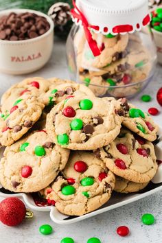 chocolate chip cookies with m & m candies and candy canes in the background