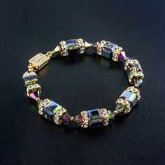 SAVE 25% with code: PINTEREST1 for a limited time! Glitterize you look with this vibrant, multicolor crystal bracelet. Each Swarovski crystal has hints of green, purple, red and blue - a beautiful accent for your next social occasion or night on the town. Handmade in USA. Crystal Bracelets Diy, Crystal Shapes, Big Night, Crystal Beads Bracelet, Box Clasp, Homemade Jewelry, A Bracelet, Beaded Jewelry Patterns, Sea Glass Jewelry